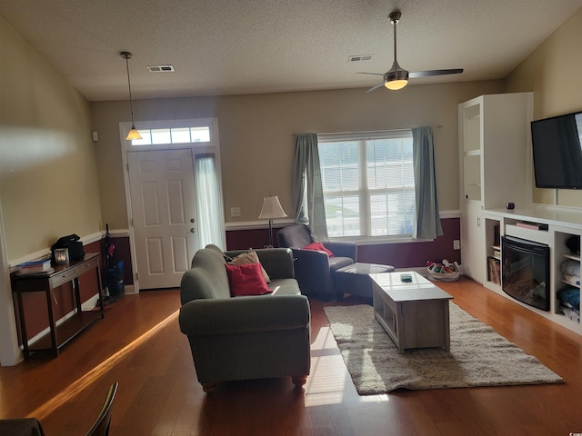 7473 Louisville Rd, Aynor, SC 29511 - living area featuring a textured ceiling, wood finished floors, ceiling fan, and visible vents