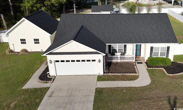 7473 Louisville Rd, Aynor, SC 29511 - view of front of house with driveway, an attached garage, a front yard, a porch, and a shingled roof