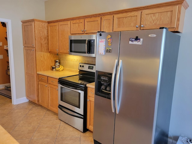 7473 Louisville Rd, Aynor, SC 29511 - kitchen with baseboards, light tile patterned floors, light countertops, decorative backsplash, and stainless steel appliances