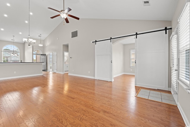 826 Sand Binder Dr, Myrtle Beach, SC 29579 - unfurnished living room with a barn door, ceiling fan, high vaulted ceiling, healthy amount of natural light, and light wood-style floors