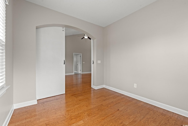 826 Sand Binder Dr, Myrtle Beach, SC 29579 - empty room featuring arched walkways, ceiling fan, and light wood-type flooring