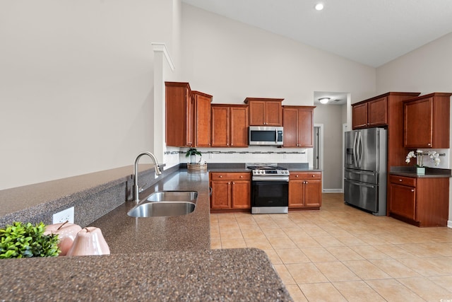 826 Sand Binder Dr, Myrtle Beach, SC 29579 - kitchen with appliances with stainless steel finishes, high vaulted ceiling, decorative backsplash, light tile patterned floors, and brown cabinets