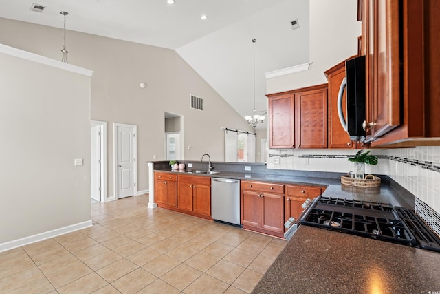 826 Sand Binder Dr, Myrtle Beach, SC 29579 - kitchen with appliances with stainless steel finishes, dark countertops, a chandelier, a peninsula, and high vaulted ceiling