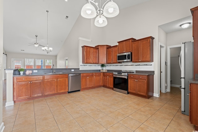 826 Sand Binder Dr, Myrtle Beach, SC 29579 - kitchen with appliances with stainless steel finishes, a chandelier, high vaulted ceiling, brown cabinetry, and ceiling fan
