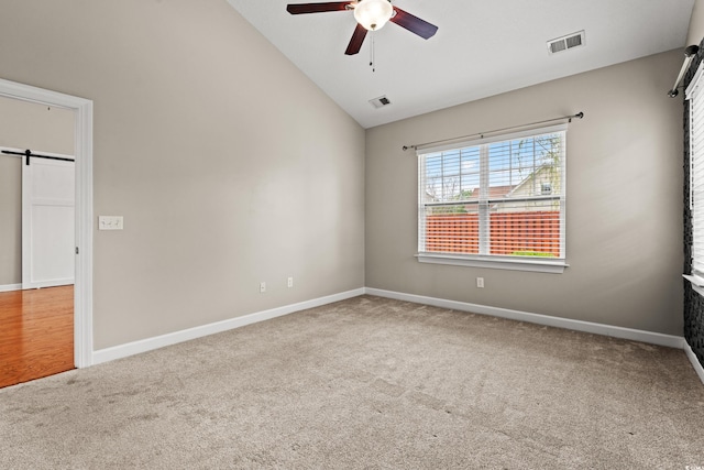 826 Sand Binder Dr, Myrtle Beach, SC 29579 - spare room featuring carpet floors, ceiling fan, a barn door, and high vaulted ceiling