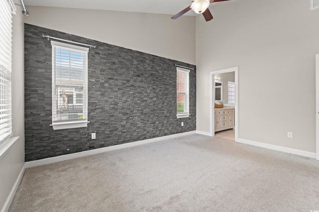 826 Sand Binder Dr, Myrtle Beach, SC 29579 - unfurnished bedroom with carpet, multiple windows, ensuite bathroom, and high vaulted ceiling