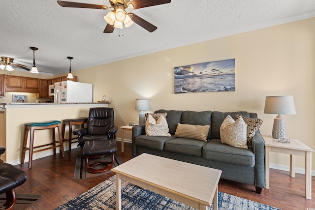 9600 Shore Dr Unit A-207, Myrtle Beach, SC 29572 - living area featuring ceiling fan, a textured ceiling, dark wood-style flooring, crown molding, and baseboards