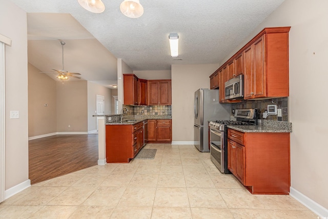 406 Pritchard St, Myrtle Beach, SC 29588 - kitchen featuring ceiling fan, dark stone counters, stainless steel appliances, a peninsula, and tasteful backsplash