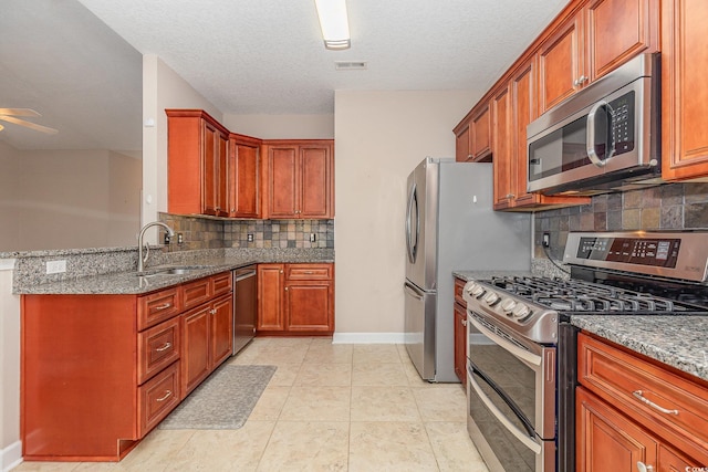 406 Pritchard St, Myrtle Beach, SC 29588 - kitchen featuring stainless steel appliances, baseboards, light stone counters, and a sink