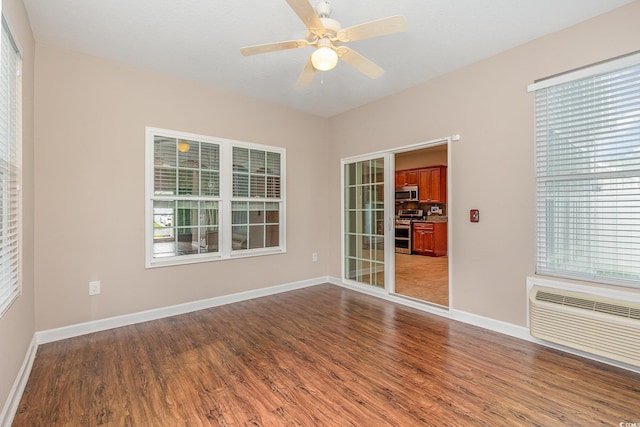 406 Pritchard St, Myrtle Beach, SC 29588 - unfurnished room with baseboards, ceiling fan, dark wood-style floors, and a wall mounted air conditioner