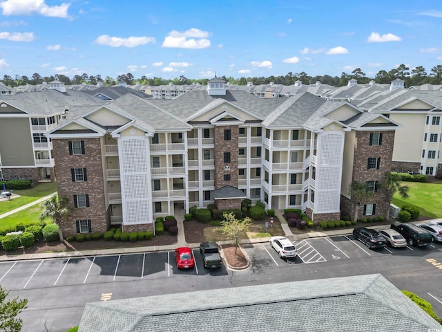 4861 Luster Leaf Cir Unit 104, Myrtle Beach, SC 29577 - view of building exterior featuring uncovered parking and a residential view