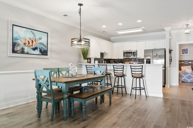 4861 Luster Leaf Cir Unit 104, Myrtle Beach, SC 29577 - dining area featuring crown molding, light wood-style flooring, and recessed lighting