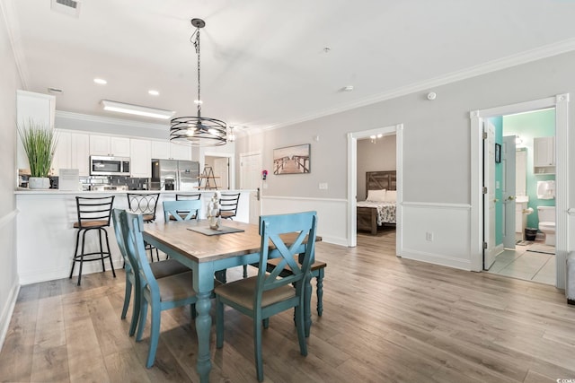 4861 Luster Leaf Cir Unit 104, Myrtle Beach, SC 29577 - dining room featuring crown molding, light wood-type flooring, a chandelier, recessed lighting, and baseboards