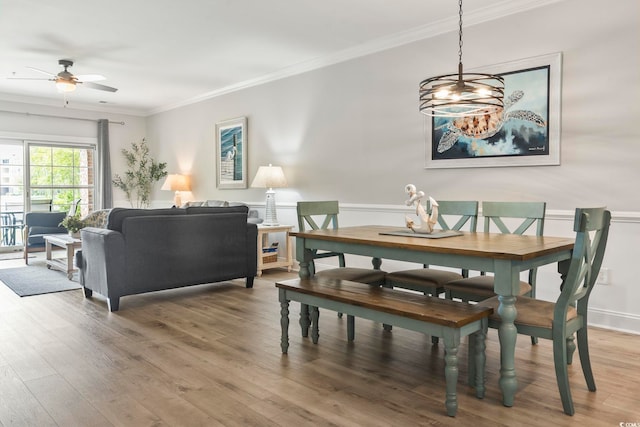 4861 Luster Leaf Cir Unit 104, Myrtle Beach, SC 29577 - dining room featuring a ceiling fan, ornamental molding, light wood-style floors, and a chandelier