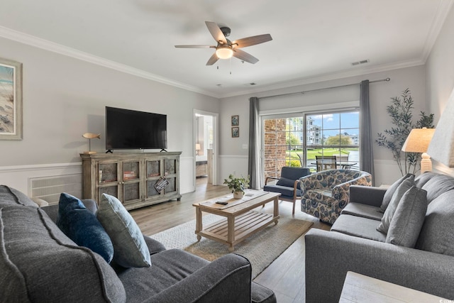4861 Luster Leaf Cir Unit 104, Myrtle Beach, SC 29577 - living area with light wood-style floors, wainscoting, ceiling fan, and ornamental molding