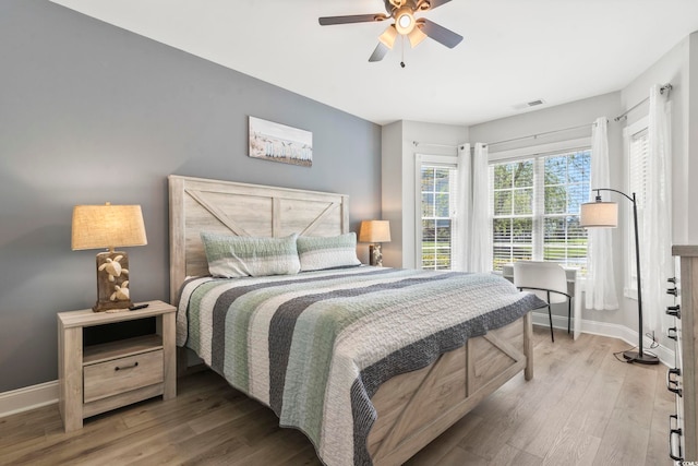 4861 Luster Leaf Cir Unit 104, Myrtle Beach, SC 29577 - bedroom featuring baseboards, wood finished floors, and ceiling fan