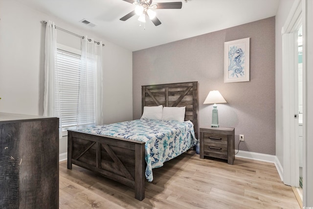 4861 Luster Leaf Cir Unit 104, Myrtle Beach, SC 29577 - bedroom featuring wood finished floors, baseboards, a ceiling fan, and multiple windows