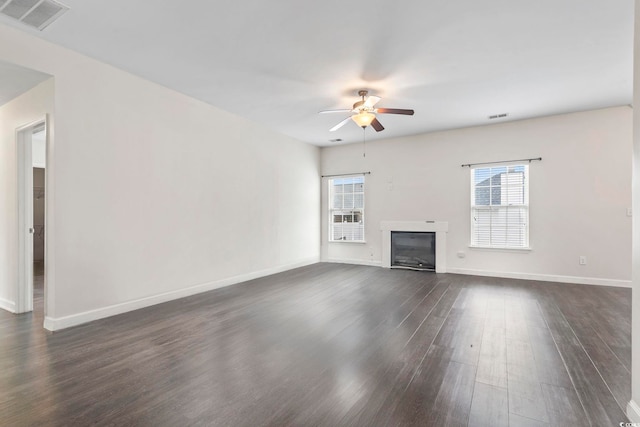 601 Seth Ln, Longs, SC 29568 - unfurnished living room with a ceiling fan, dark wood-style floors, a glass covered fireplace, and baseboards