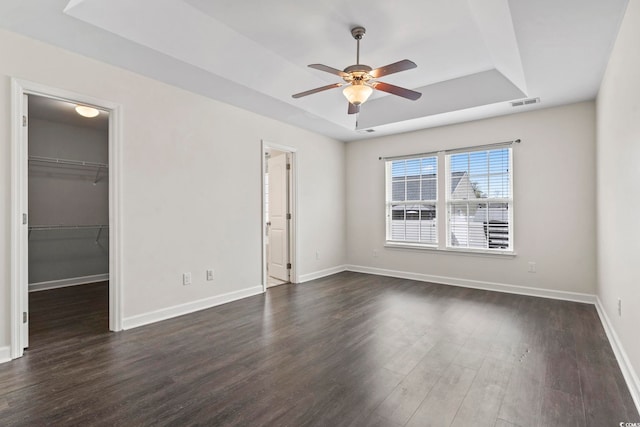 601 Seth Ln, Longs, SC 29568 - spare room featuring a raised ceiling, ceiling fan, dark wood-type flooring, and baseboards