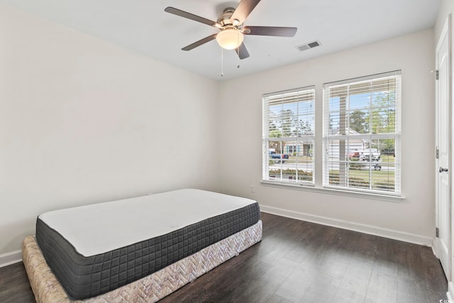 601 Seth Ln, Longs, SC 29568 - bedroom featuring baseboards, multiple windows, dark wood finished floors, and a ceiling fan