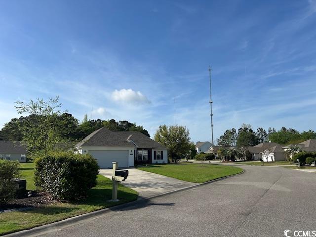 232 Marbella Dr, Murrells Inlet, SC 29576 - view of front facade with an attached garage, driveway, a front lawn, and a residential view
