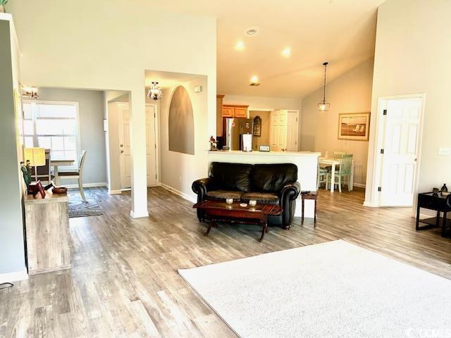 232 Marbella Dr, Murrells Inlet, SC 29576 - living area with light wood-style flooring, baseboards, and high vaulted ceiling