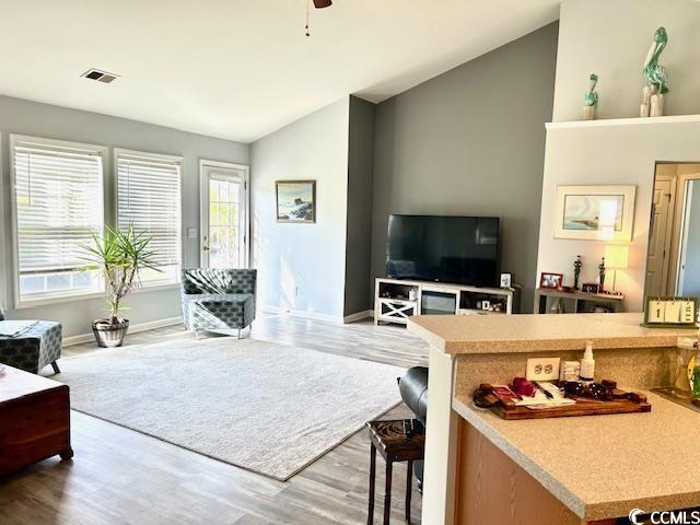 232 Marbella Dr, Murrells Inlet, SC 29576 - living area featuring vaulted ceiling, wood finished floors, baseboards, and ceiling fan
