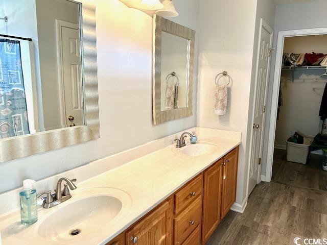 232 Marbella Dr, Murrells Inlet, SC 29576 - bathroom with wood finished floors, double vanity, and a walk in closet