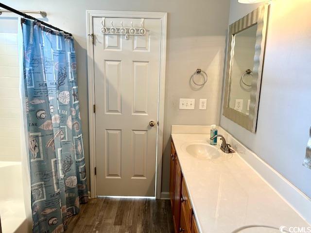 232 Marbella Dr, Murrells Inlet, SC 29576 - full bath featuring vanity, wood finished floors, and shower / bath combo with shower curtain