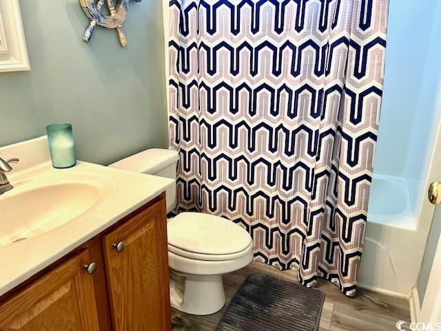 232 Marbella Dr, Murrells Inlet, SC 29576 - full bath with toilet, wood finished floors, vanity, and shower / bath combination with curtain