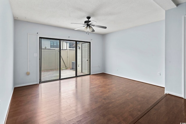 spare room featuring ceiling fan, wood finished floors, and a textured ceiling