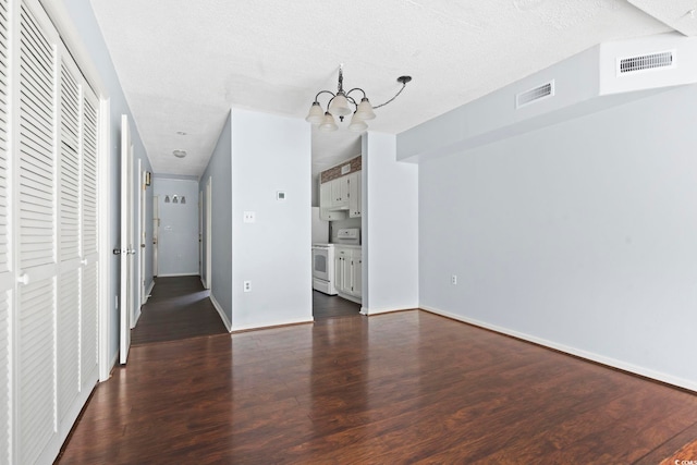 interior space featuring visible vents, a notable chandelier, wood finished floors, and a textured ceiling