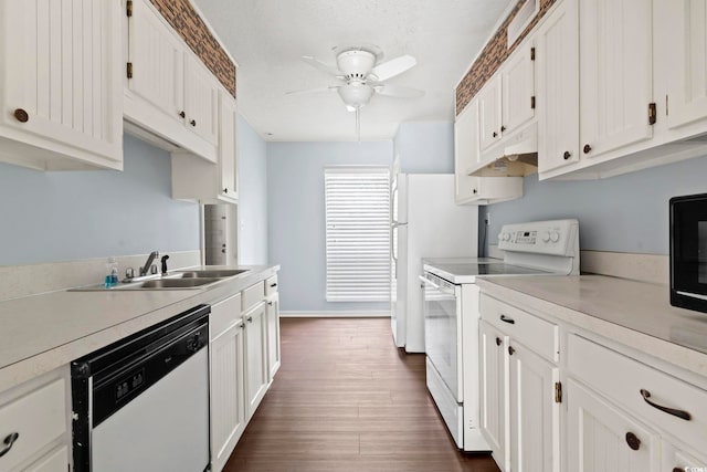 kitchen with a sink, light countertops, ceiling fan, white appliances, and white cabinetry
