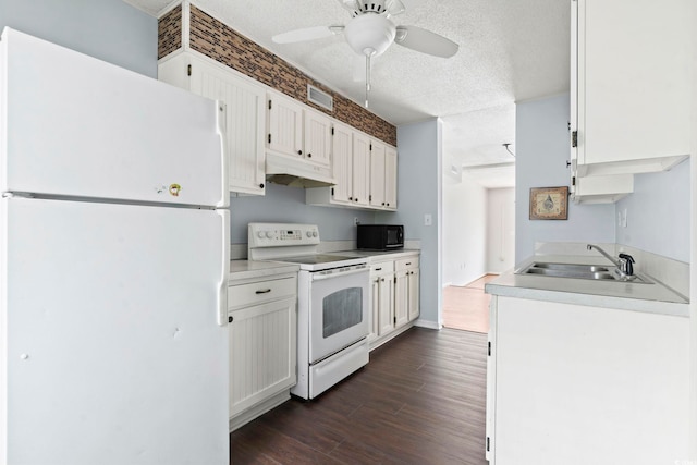 kitchen featuring white appliances, a textured ceiling, under cabinet range hood, ceiling fan, and a sink