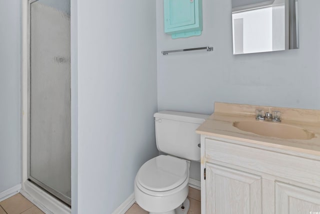 bathroom featuring toilet, baseboards, a shower stall, and vanity