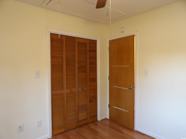1208 Mackie Cir, Myrtle Beach, SC 29579 - unfurnished bedroom with attic access, wood finished floors, a closet, and baseboards