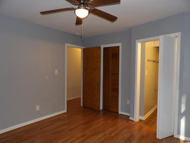 1208 Mackie Cir, Myrtle Beach, SC 29579 - unfurnished bedroom with wood finished floors, baseboards, ceiling fan, and a closet