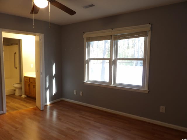 1208 Mackie Cir, Myrtle Beach, SC 29579 - unfurnished bedroom with light wood-style floors, ensuite bath, and baseboards