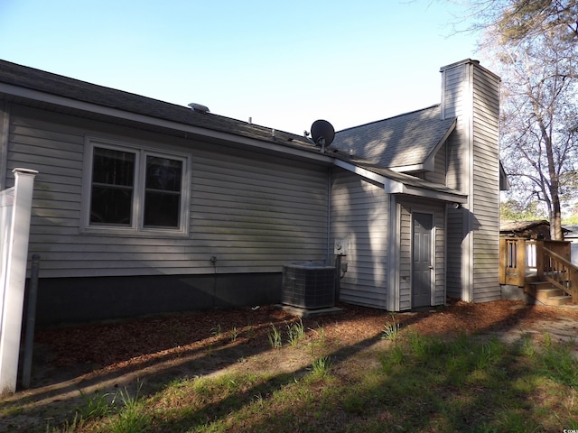 1208 Mackie Cir, Myrtle Beach, SC 29579 - rear view of house with central air condition unit and a chimney