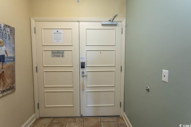 doorway to outside with baseboards