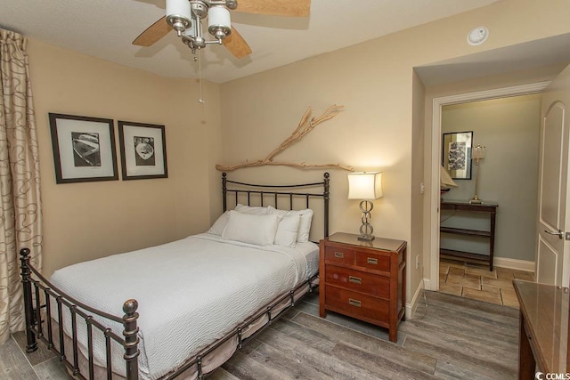 bedroom with ceiling fan and wood finished floors