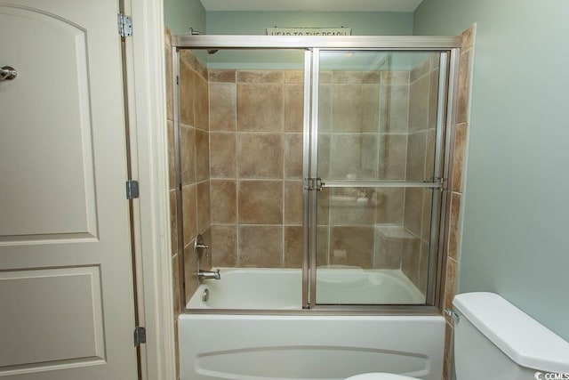 bathroom with enclosed tub / shower combo and toilet