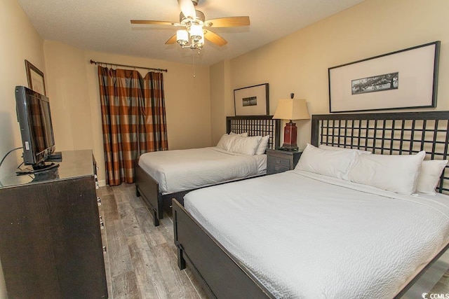 bedroom with ceiling fan and light wood-type flooring