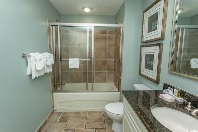 full bathroom with vanity, baseboards, combined bath / shower with glass door, and toilet