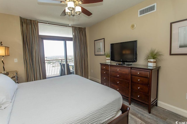bedroom featuring visible vents, wood finished floors, baseboards, access to outside, and a ceiling fan