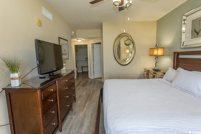 bedroom with visible vents and wood finished floors