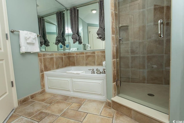 bathroom with a shower stall, a bath, and stone tile flooring