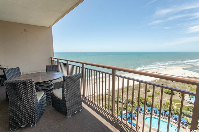 balcony with a beach view and a water view