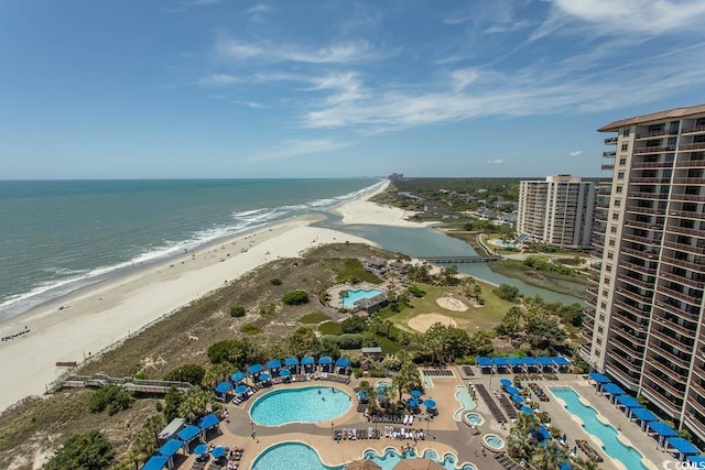 birds eye view of property featuring a water view and a view of the beach