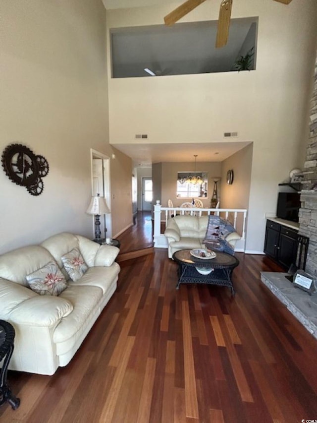 4396 Baldwin Ave Unit C-24, Little River, SC 29566 - living area with dark wood-type flooring, a towering ceiling, ceiling fan, a chandelier, and a fireplace